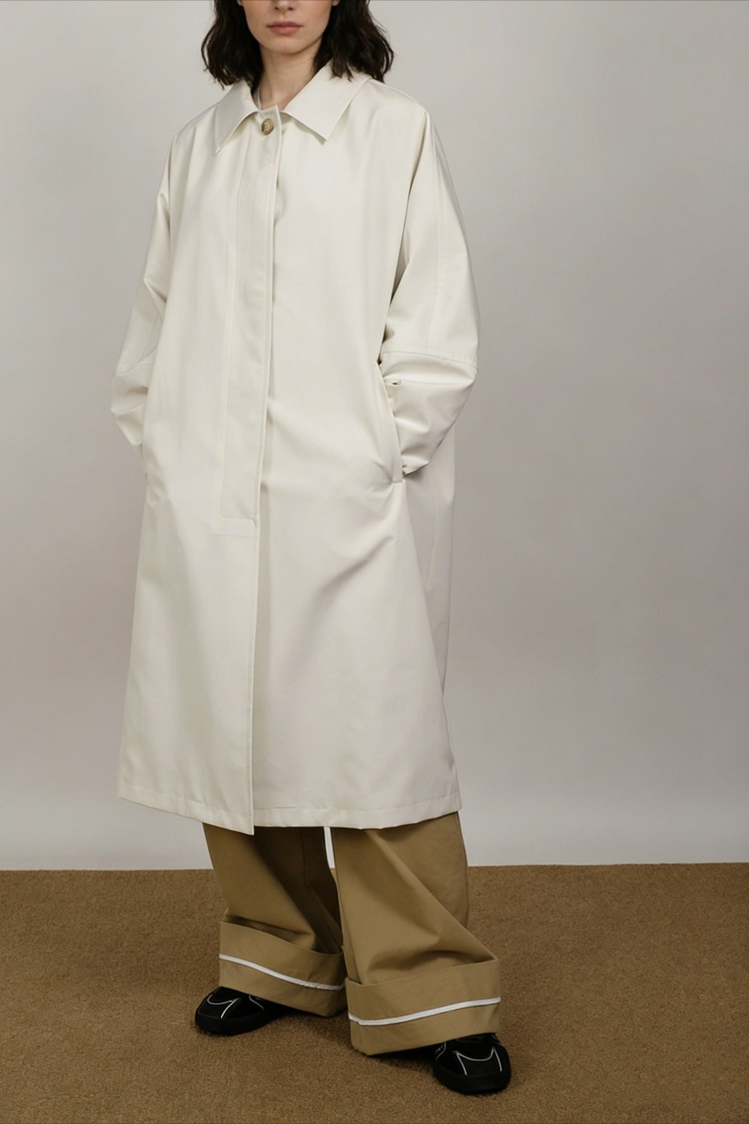 Minimalist silhouetted mid-length trench
